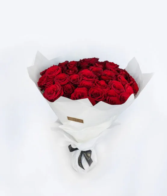 red roses in a hand bouquet